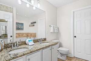 Bathroom 1  Step into your bright bathroom featuring granite countertops, dual sinks, and fresh towels waiting for your arrival.