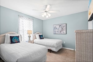 Bedroom 3  Drift off peacefully in your serene twin bedroom with soft blue walls and coastal charm.