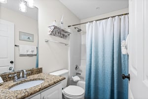 Bathroom 2  Step into your spotless shared bathroom featuring granite counters, fluffy towels, and a refreshing shower to unwind after your adventures.