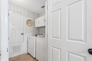 Your dedicated laundry room features fullsize washer and dryer with convenient upper storage, making extended stays effortless.