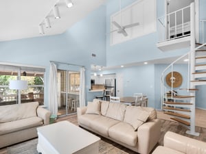 Relax in your spacious openplan living area with soaring ceilings and stylish spiral staircase to the cozy loft above.