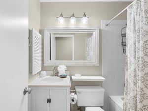 Step into your pristine bathroom with elegant white finishes, perfect lighting, and thoughtful touches that make your daily routine feel luxurious.