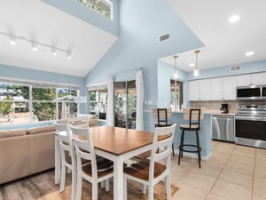 Your openconcept living space flows seamlessly from kitchen to dining, with soaring ceilings creating the perfect gathering spot.