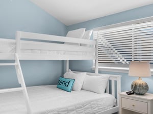 Your beachthemed bedroom features crisp white bunk beds with soft linens, perfect for family stays.