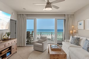Sink into plush seating as ocean breezes flow through your private balcony doors, where stunning sea views create the perfect backdrop for relaxation.
