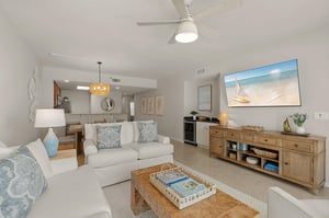 Relax in your coastalinspired living space where soft blue accents and beach artwork create a serene atmosphere.