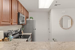 Cook your favorite meals in this wellequipped kitchen featuring granite counters and new stainless appliances.