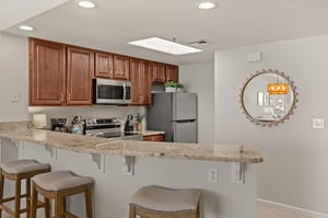 Your fully equipped kitchen features granite counters, stainless appliances, and a breakfast bar perfect for morning coffee or casual meals.