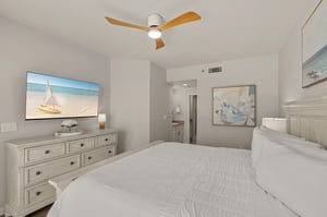 Bedroom 1 where crisp white linens and gentle sea breeze artwork create your perfect retreat.