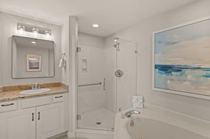 Unwind in your elegant spalike bathroom featuring a granite vanity, glassenclosed shower, and soaking tub.