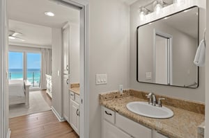 Step into your elegantly appointed bathroom where stunning ocean views greet you from the adjoining bedroom.