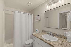 Step into your sparkling clean bathroom featuring granite countertops, elegant lighting, and fresh towels waiting for you.