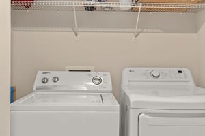 Your dedicated laundry space keeps your wardrobe fresh throughout your stay, with convenient wire shelving for storage above.