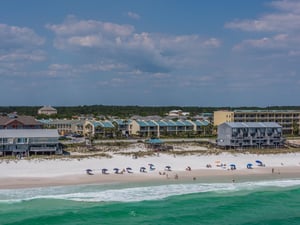 Pristine white sand beach meets emerald Gulf waters in this stunning coastal community setting.