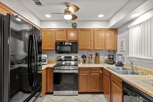 The fully equipped kitchen features stainless steel appliances