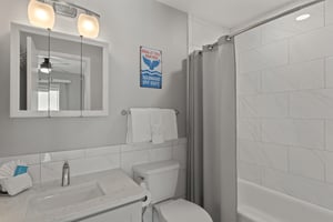Bathroom 2 has a tub, perfect for soaking after a day at the beach
