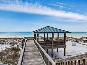Elevated beachside pavilion with stunning Gulf Coast views and pristine white sand stretching to turquoise waters.