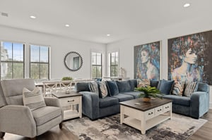 Your openconcept living space welcomes you with stylish coastal charm—plush seating, contemporary art, and sunlit comfort for unforgettable moments together.