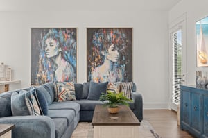 Sink into plush sectional seating beneath striking artwork, where your vacation moments unfold in this thoughtfully designed living space with tasteful coastalinspired touches.
