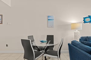 Gather around this sleek glass dining table, where modern style meets coastal charm. The soft lighting and oceaninspired décor create a welcoming atmosphere for your meals together.