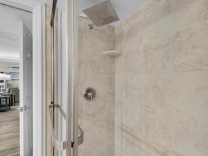 Step into your private rainfall shower with elegant tile work and modern fixtures, perfect for refreshing after a day of adventure.