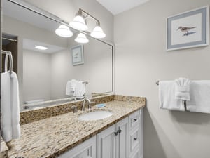 Bathroom 2 with bright vanity lighting, and plush white towels waiting just for you. Thoughtful coastal touches create a calming retreat after your day exploring.