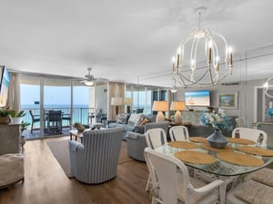 Unwind in your spacious living and dining area, where panoramic gulf views through floortoceiling glass doors frame every moment, blending coastal elegance with effortless comfort.
