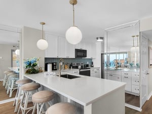 Picture yourself cooking in this bright, beachside kitchen with gulf views, spacious counters, and bar seating perfect for morning coffee with family and friends.