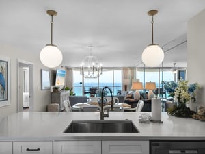 Prepare your favorite meals in a sleek, modern kitchen while enjoying stunning gulf views through floortoceiling windows. The open layout flows into a welcoming living space, perfect for your getawa