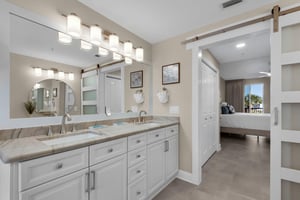 Step into the bright, spalike bathroom with dual sinks and sleek cabinetry