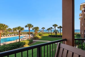 Soak in sweeping views of the sparkling pool, manicured lawns, swaying palms, and the shimmering ocean beyond from the comfort of your private balcony.