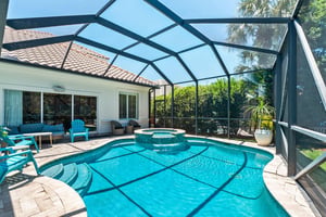take a refreshing dip in your private screened pool, then relax on the sun loungers