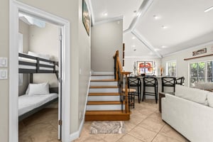 A cozy bunk room awaits nearby, while the dining and living spaces invite you to relax and gather.