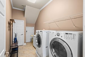 A dedicated laundry space awaits, complete with a fullsize washer and dryer—