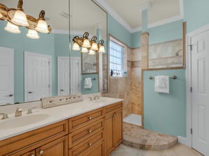 The 2nd floor bathroom features soothing aqua tones and a spacious walk in shower and double vanities.