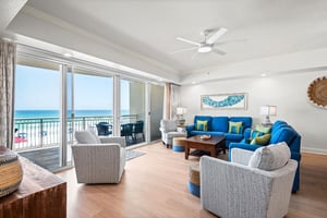 Step into your sunlit living room where cozy seating invite you to unwind after a day at the beach.