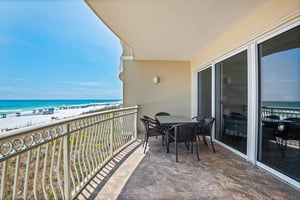The balcony overlooks pristine white sands and vibrant beach life—perfect for unwinding in paradise.