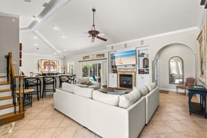 Unwind in the spacious living room with soaring ceilings, a cozy fireplace, and plenty of room to relax