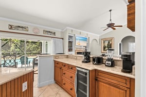 The gourmet kitchen awaits with quality appliances, and a coffee station—