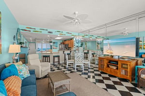Tropical living area opens to kitchen, dining,  hallway that leads to two bedrooms  front door.