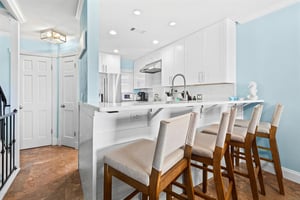 The modern kitchen features a breakfast bar perfect for morning coffee or casual meals.