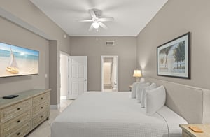 Drift off to sleep in this serene bedroom with coastal touches. Plush bedding, coastal artwork, and a ceiling fan create your perfect retreat after a day of adventure.