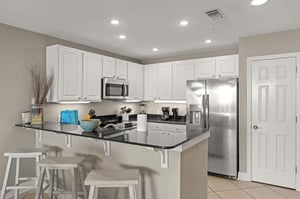 Kitchen with stainless steel appliances, granite countertops, and a convenient breakfast bar where you can gather for morning coffee and family meals.