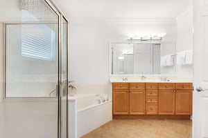 Refresh in your private spalike bathroom with a soaking tub, walkin shower, dual vanities, and warm wood finishes throughout.
