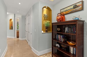 Step into this private retreat through this elegant hallway featuring tasteful décor, builtin alcoves with warm lighting, and thoughtful touches that make you feel at home from the moment you arrive.
