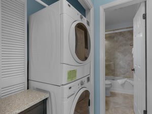 Laundry center and guest bathroom with barn door at hall way for privacy