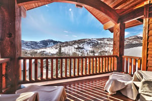 A private covered patio off the first main bedroom with Deer Valley Resort views, and wood deck, railing, ceiling and beams.