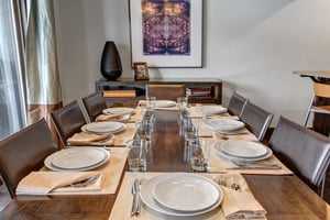 The dining area with seating and table settings for 8 guests.