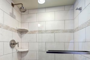 The bathroom with a walkin tiled shower.