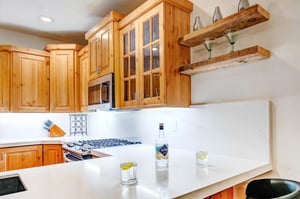 Youll love preparing meals in this bright, fullyequipped kitchen with warm wood cabinetry.